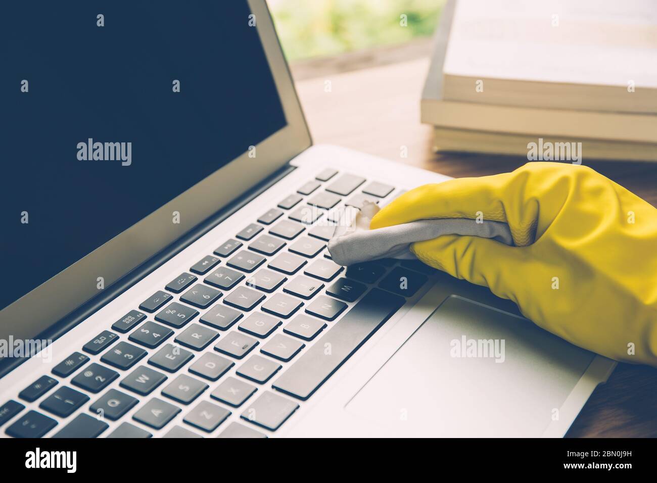 Hand of man cleaning keyboard computer with antibacterial for protect epidemic disease covid19