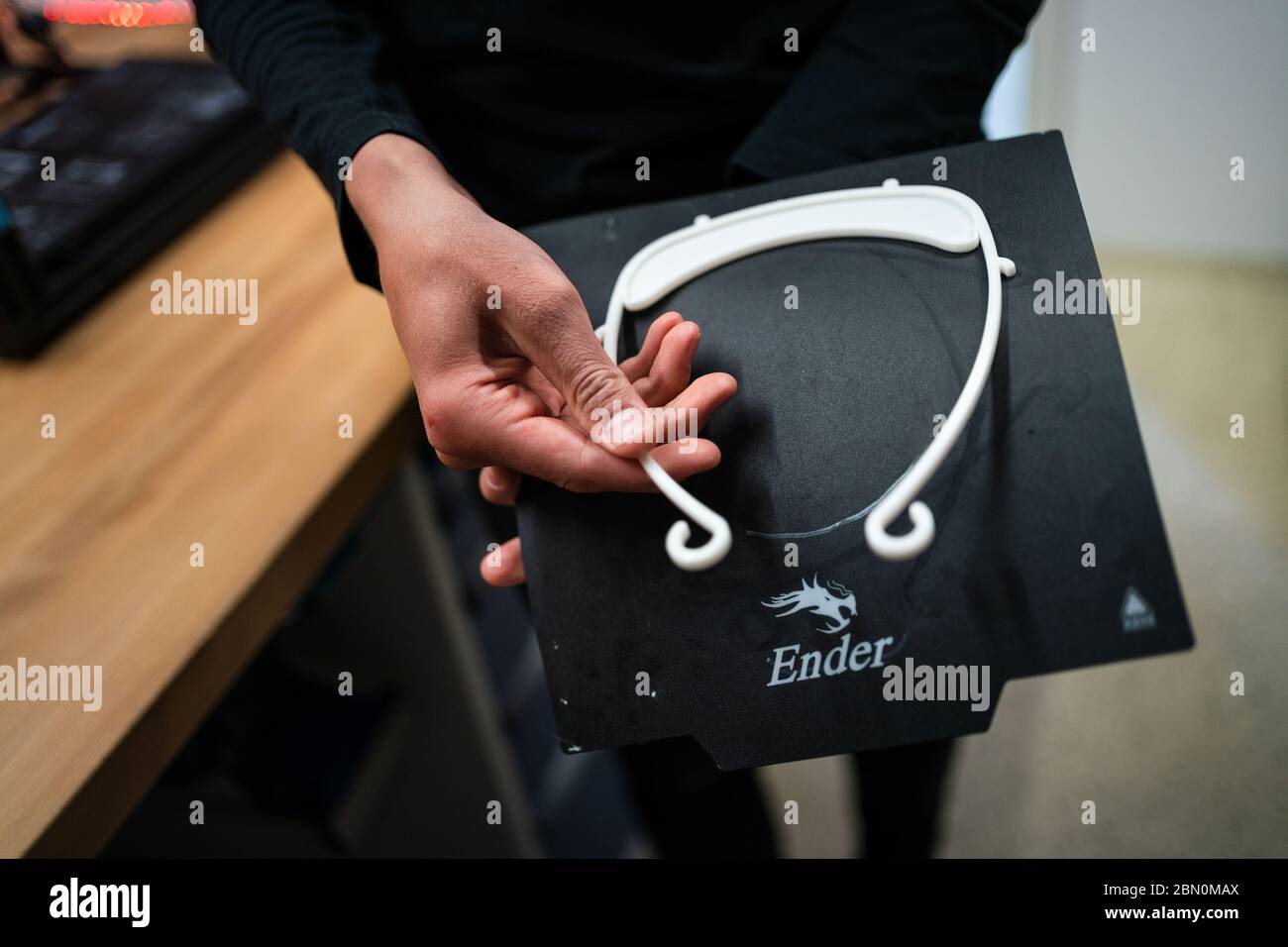 Kulmbach, Germany. 23rd Apr, 2020. The student of the Markgraf-Georg-Friedrich-Gymnasium, Josias Neumüller, demonstrates how to attach the holder for the Faceshield, which he printed in 3D, to the head. Credit: Nicolas Armer/dpa/Alamy Live News Stock Photo