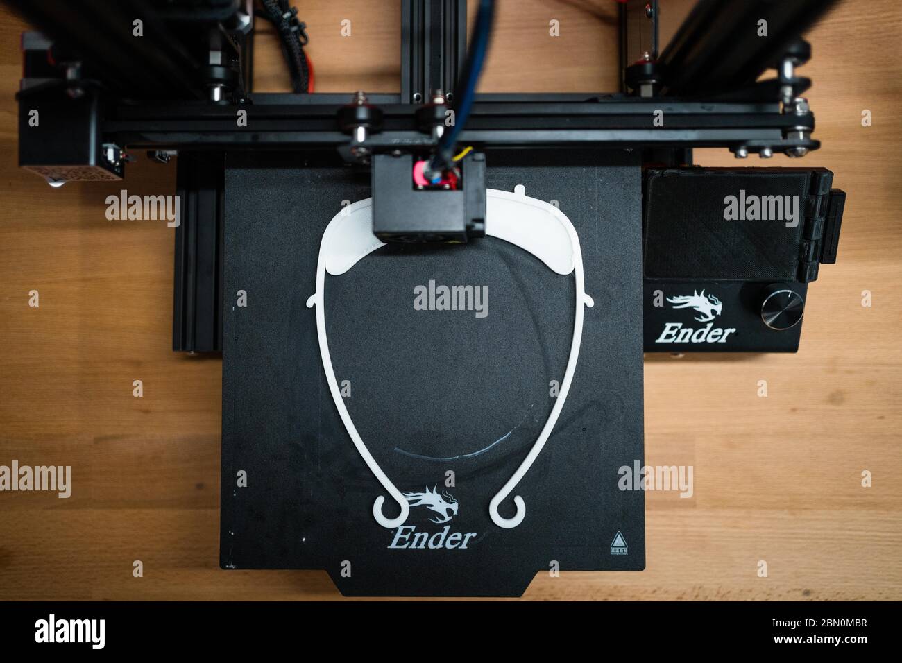 Kulmbach, Germany. 23rd Apr, 2020. The student of the Markgraf-Georg-Friedrich-Gymnasium, Josias Neumüller, demonstrates how to attach the holder for the Faceshield, which he printed in 3D, to the head. Credit: Nicolas Armer/dpa/Alamy Live News Stock Photo