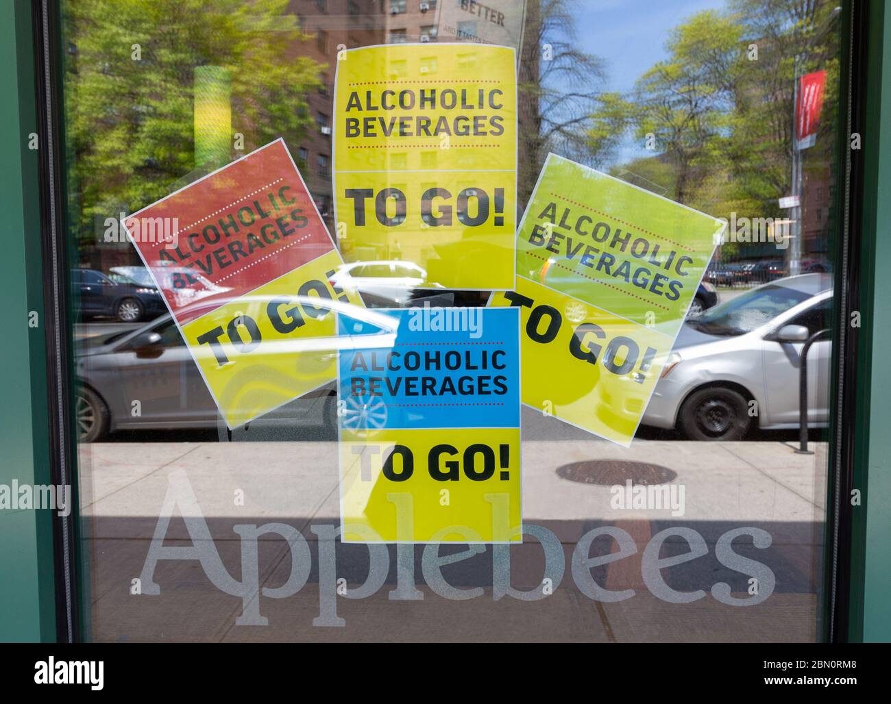 Applebees is aggressively advertising its alcoholic beverages to go with these multiple signs during the coronavirus or covid-19 pandemic Stock Photo