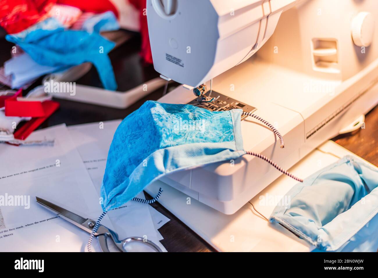 Cloth Surgical Mask on Sewing Machine during the Covid-19 pandemic. Stock Photo