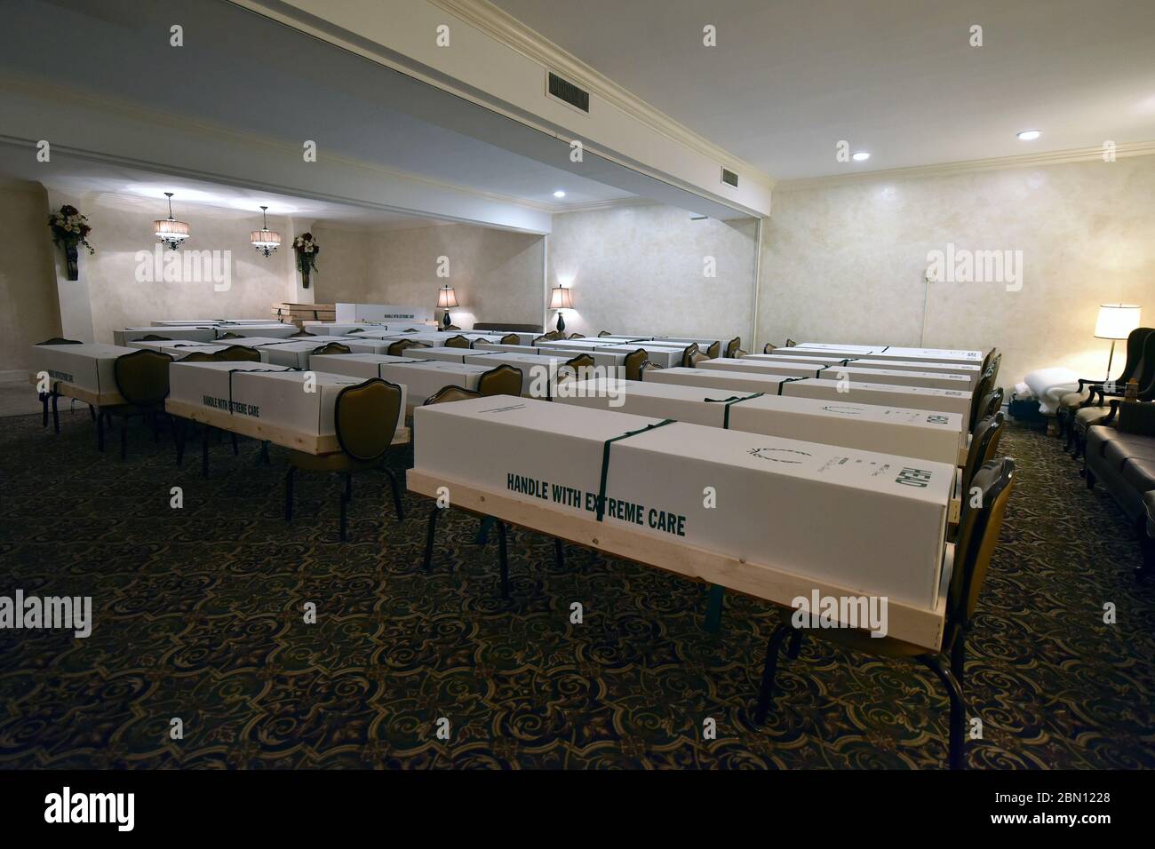 Bodies In Cremation Funeral Caskets Are Lined Up In Rows Sitting On Chairs In The Chapel Section Of Gerard J Neufeld Funeral Home Waiting To Be Loaded Onto A Truck To Be