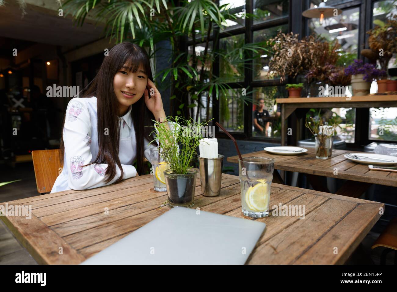 Happy young beautiful Asian woman sitting at the coffee shop Stock ...