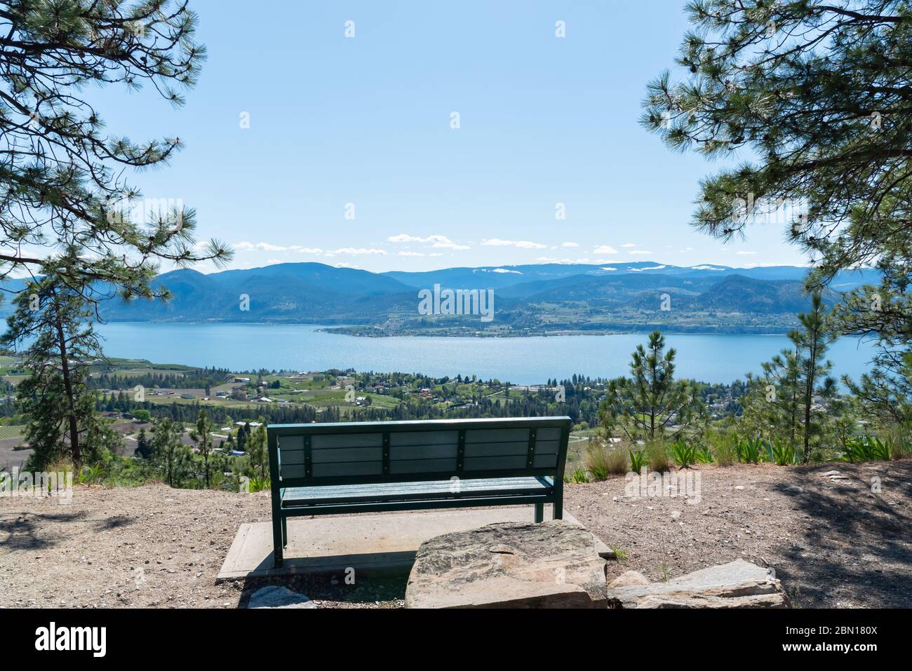 Park bench at scenic viewpoint on Kettle Valley Rail Trail with view of