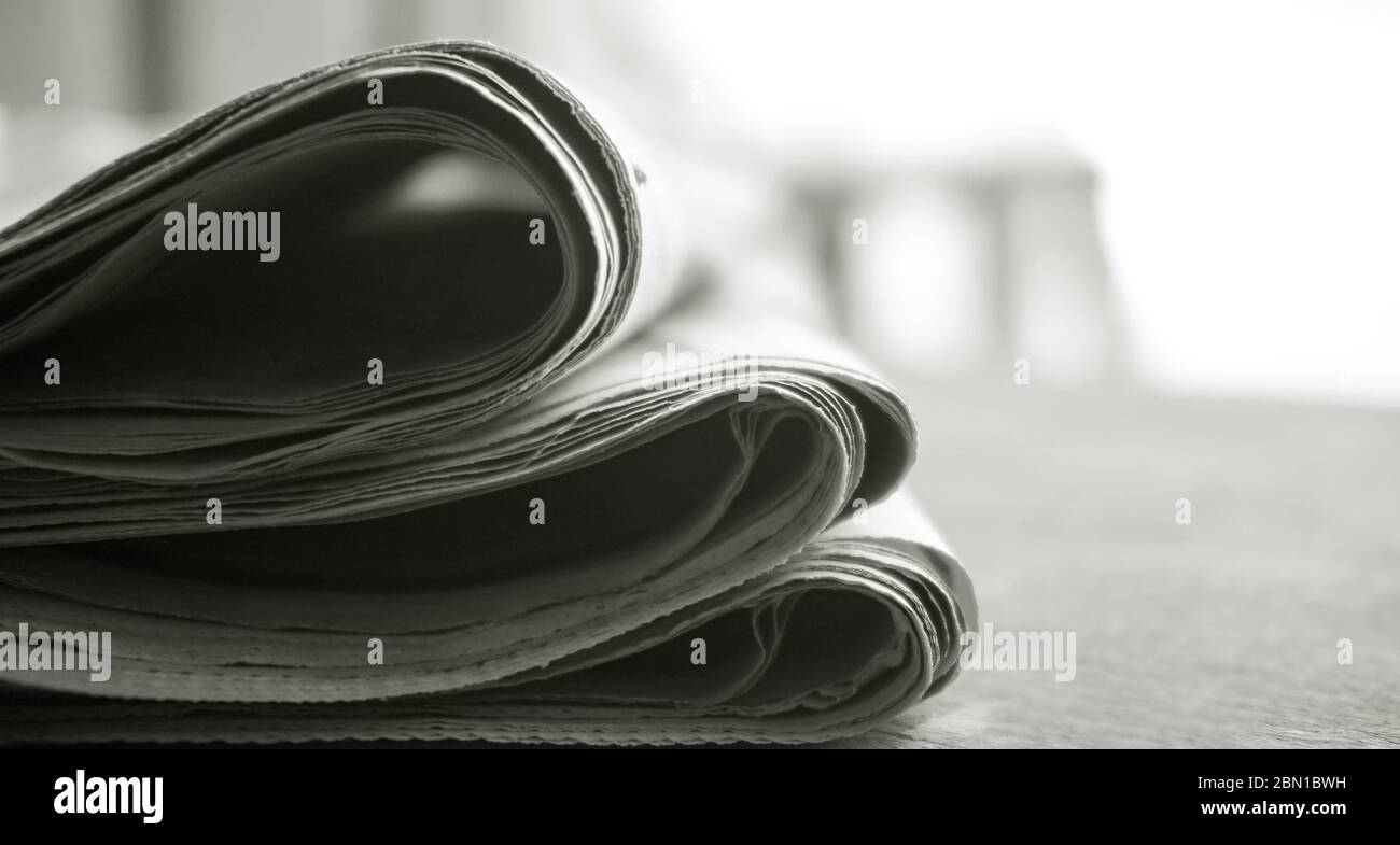 rolled up newspaper stack background Stock Photo