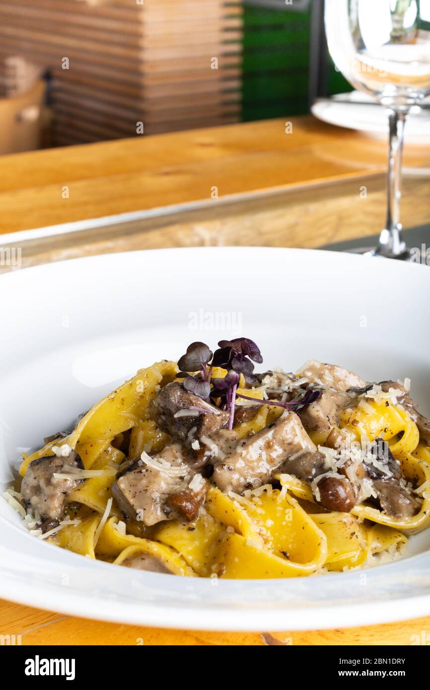 Fresh pappardelle pasta with porcini mushrooms and truffle scent. Traditional italian dish