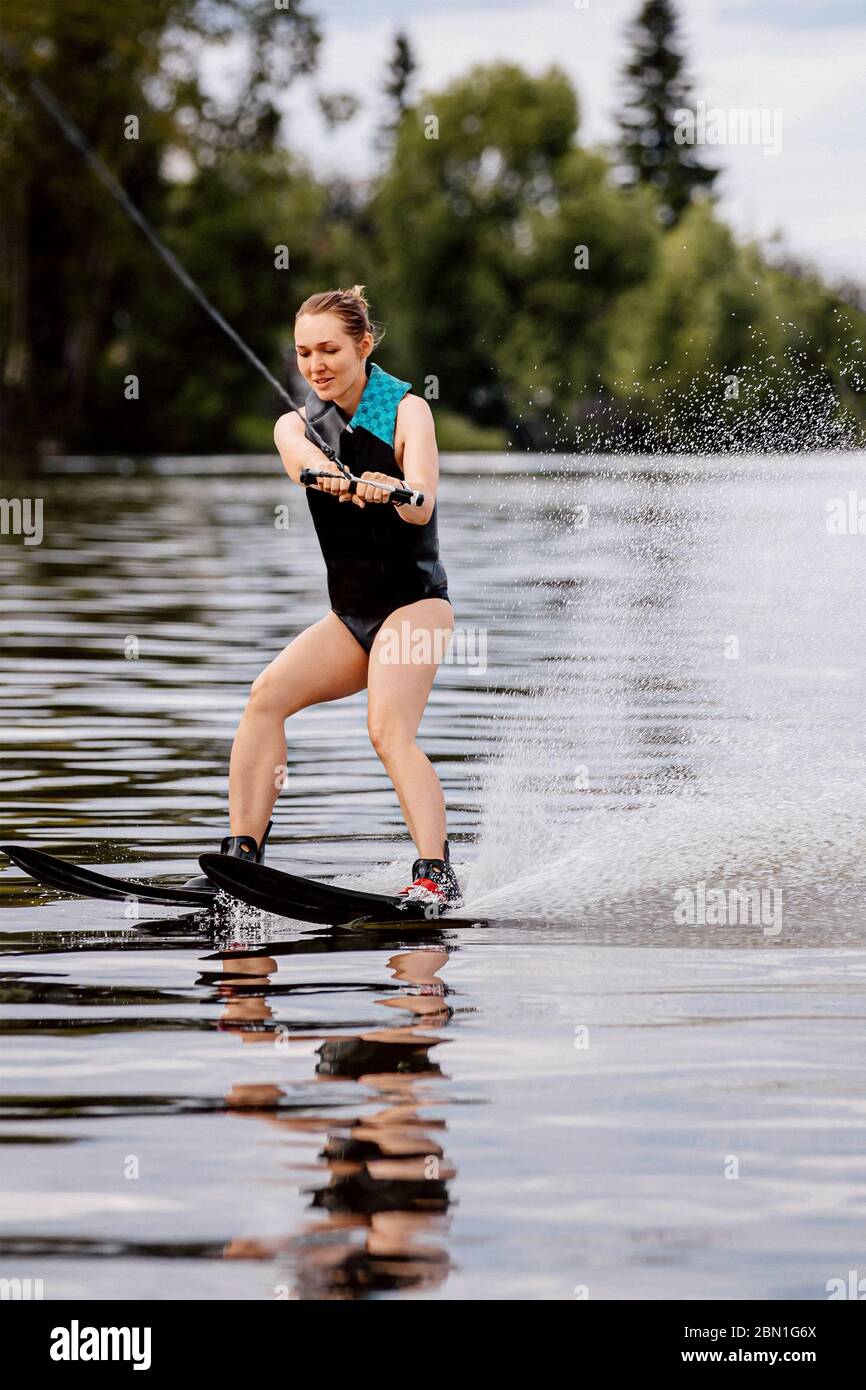 girl on water skiing riding on lake in summer Stock Photo