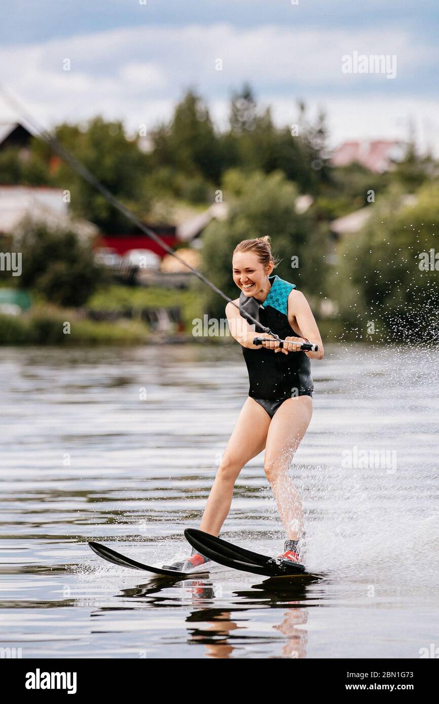 beautiful girl on water skiing riding on lake in summer Stock Photo