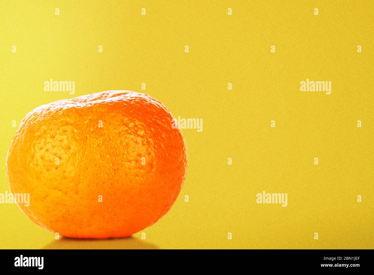 Oranges on vivid yellow background Stock Photo - Alamy