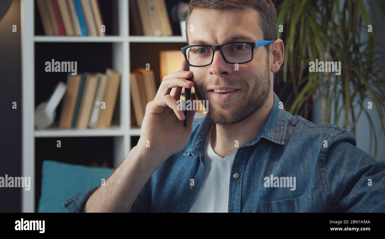 Bearded man talking on smartphone Stock Photo