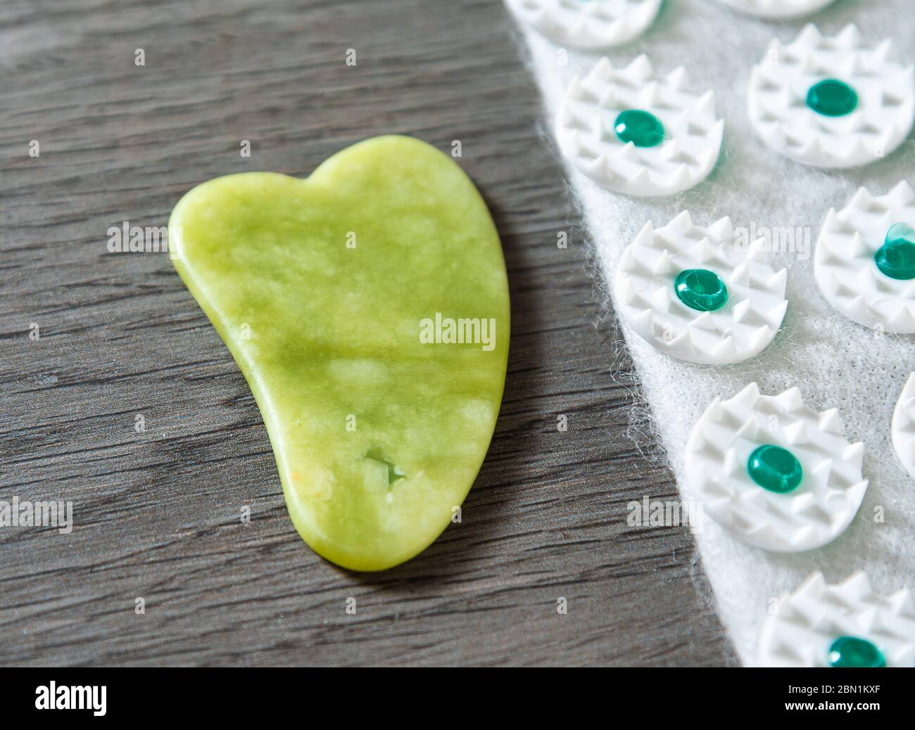 Gua sha tool in natural gemstone of green Jade with Acupressure mat