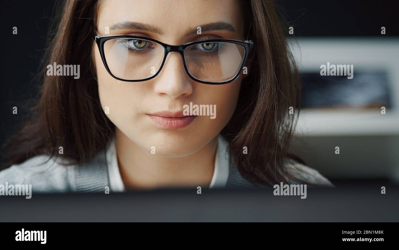 Woman working on computer, headshot Stock Photo