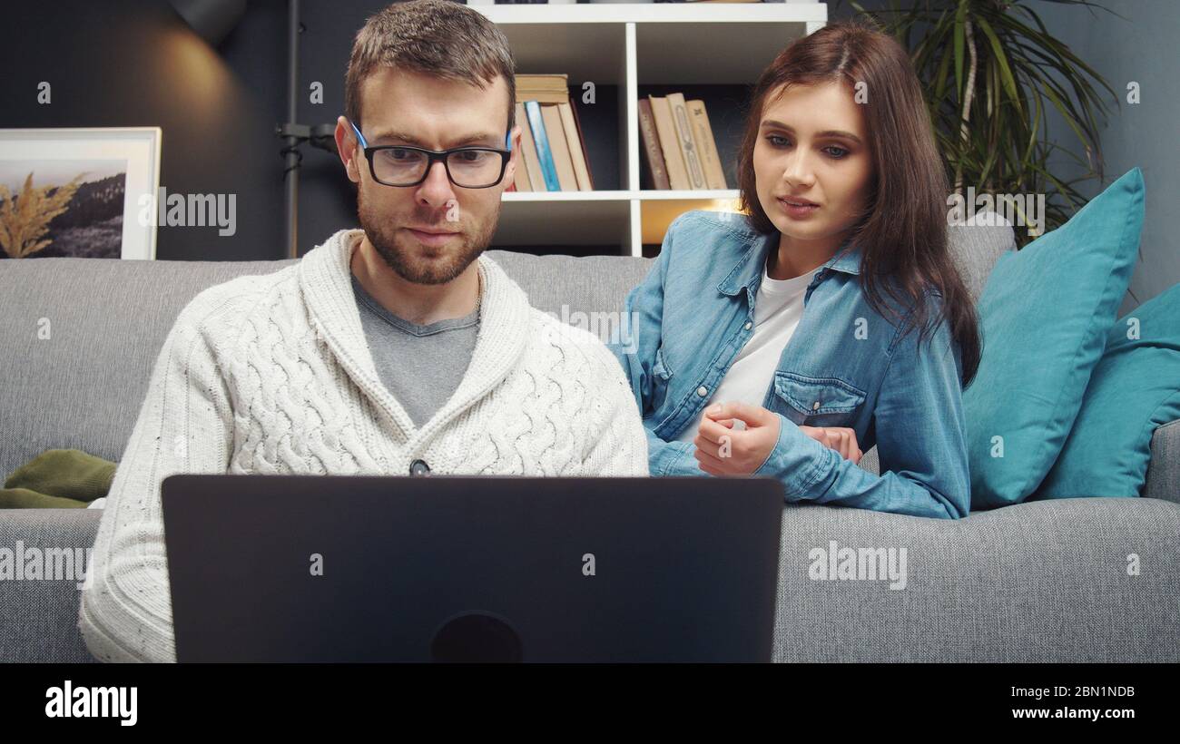 Couple looking at laptop screen Stock Photo
