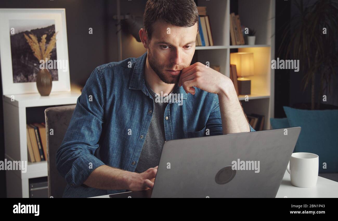 Man using laptop working home Stock Photo