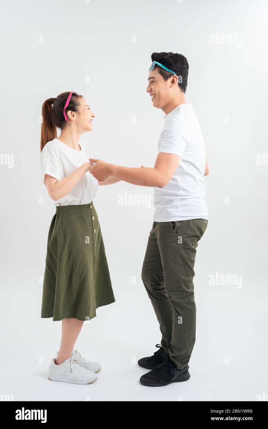 Full length shot of asian couple isolated on white. Man in casual attire chilling with girlfriend Stock Photo