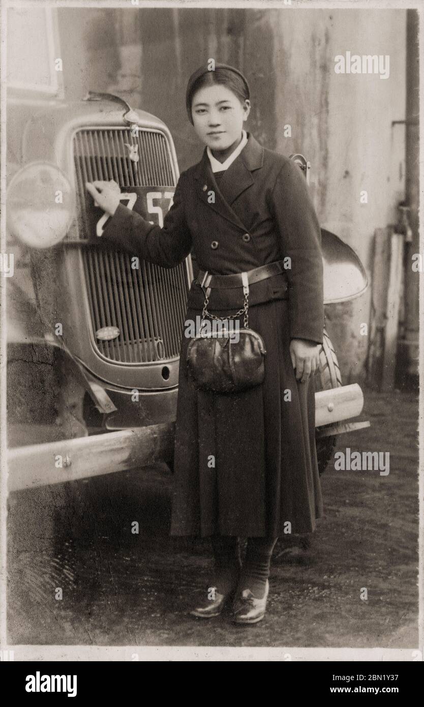 [ 1940s Japan - Female Bus Conductor ] —   Japanese female bus conductor, popularly known as “Bus Girl” (バスガール).  20th century vintage gelatin silver print. Stock Photo