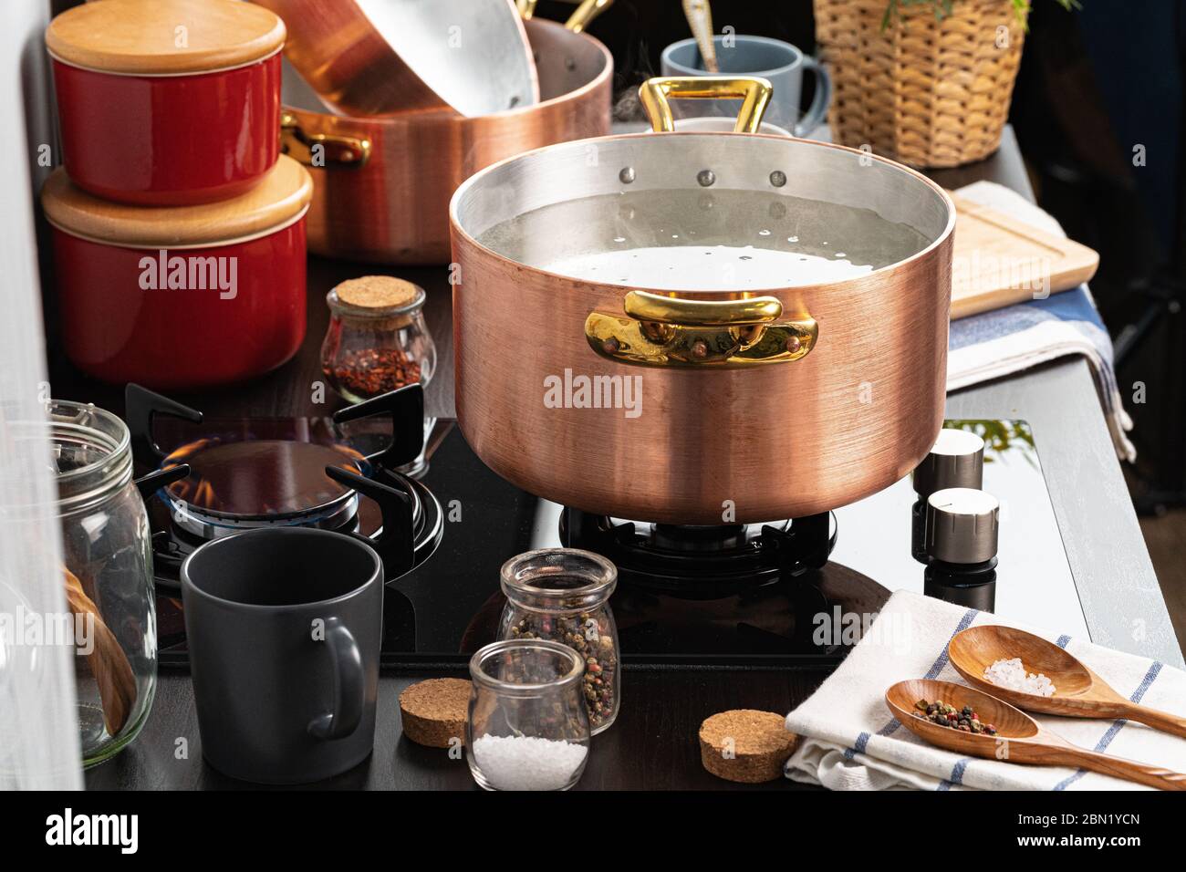 Copper pot with boiling water on a gas stove Stock Photo Alamy