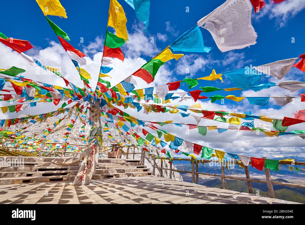Top of the Shika Snow Mountain (4500 meters above the sea level) with Buddhist prayer flags, China. Stock Photo