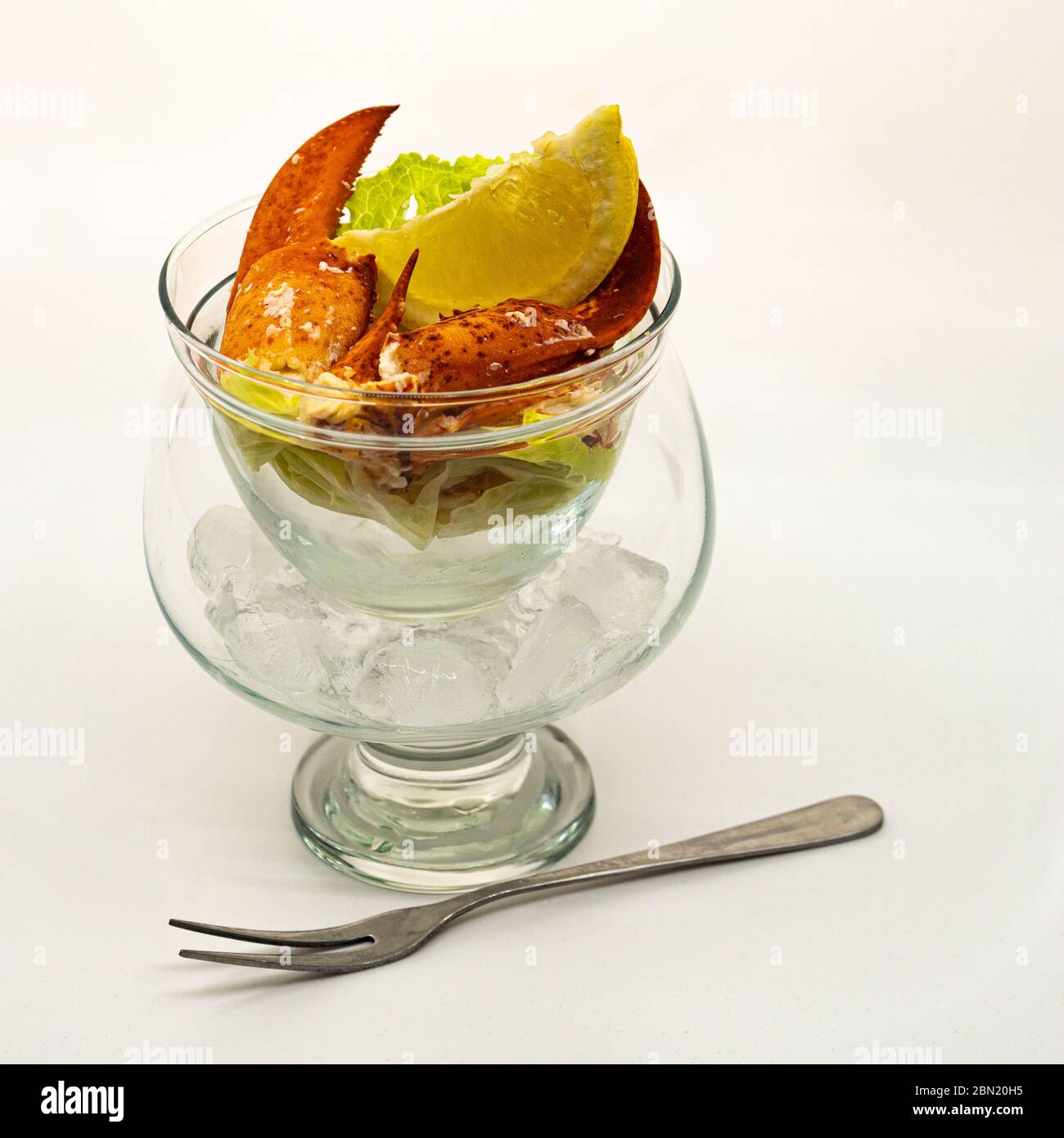 One lobster cocktail and seafood fork isolated on white. Stock Photo