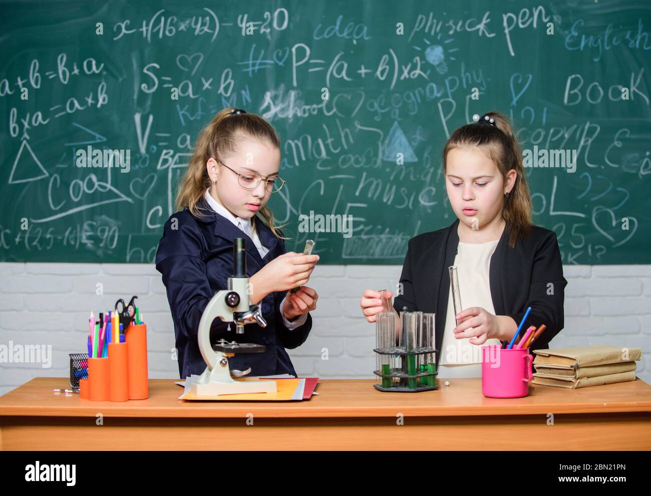 Scientific researches. Little scientist work with microscope. Little girls in school lab. Formal school education. Biology school lesson. Chemistry research. science experiments in laboratory. Stock Photo