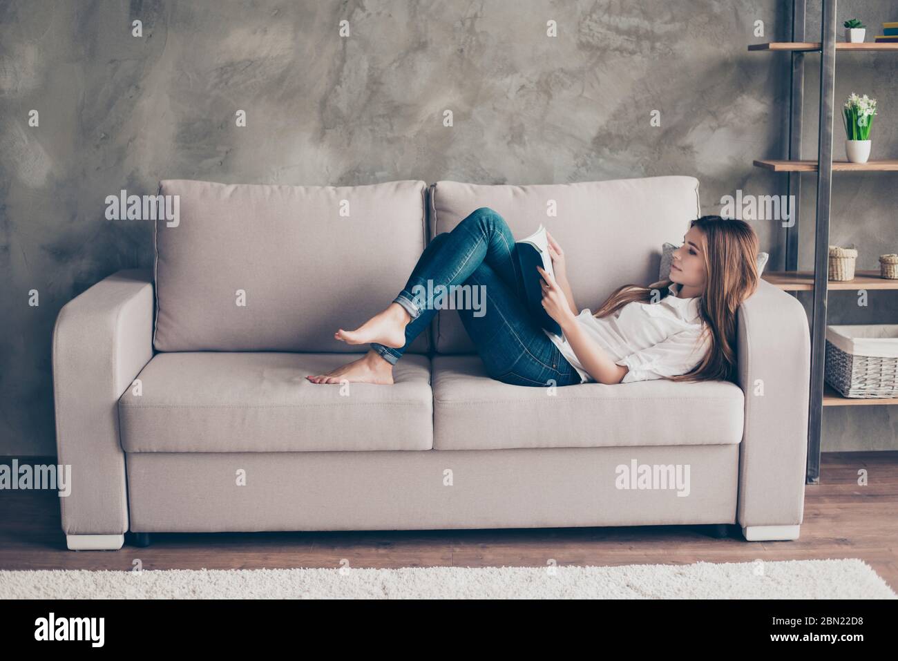 Barefoot girl lying on couch hi-res stock photography and images - Alamy