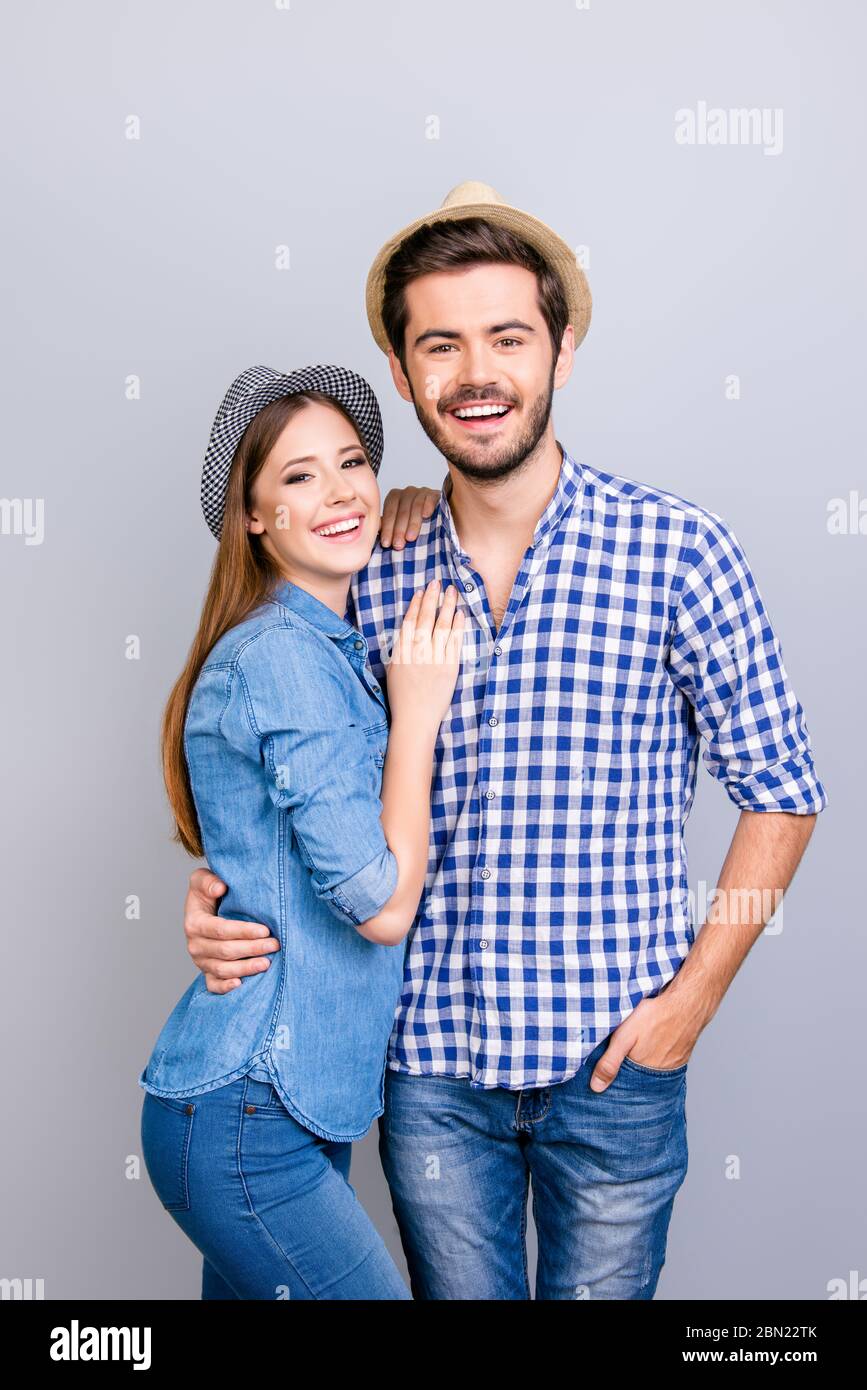 Beautiful couple in stylish casual clothes stands on a bright urban  background and poses at the camera. Young couple posing on a date, street  love story photo. Valentine's day concept. Stock Photo |
