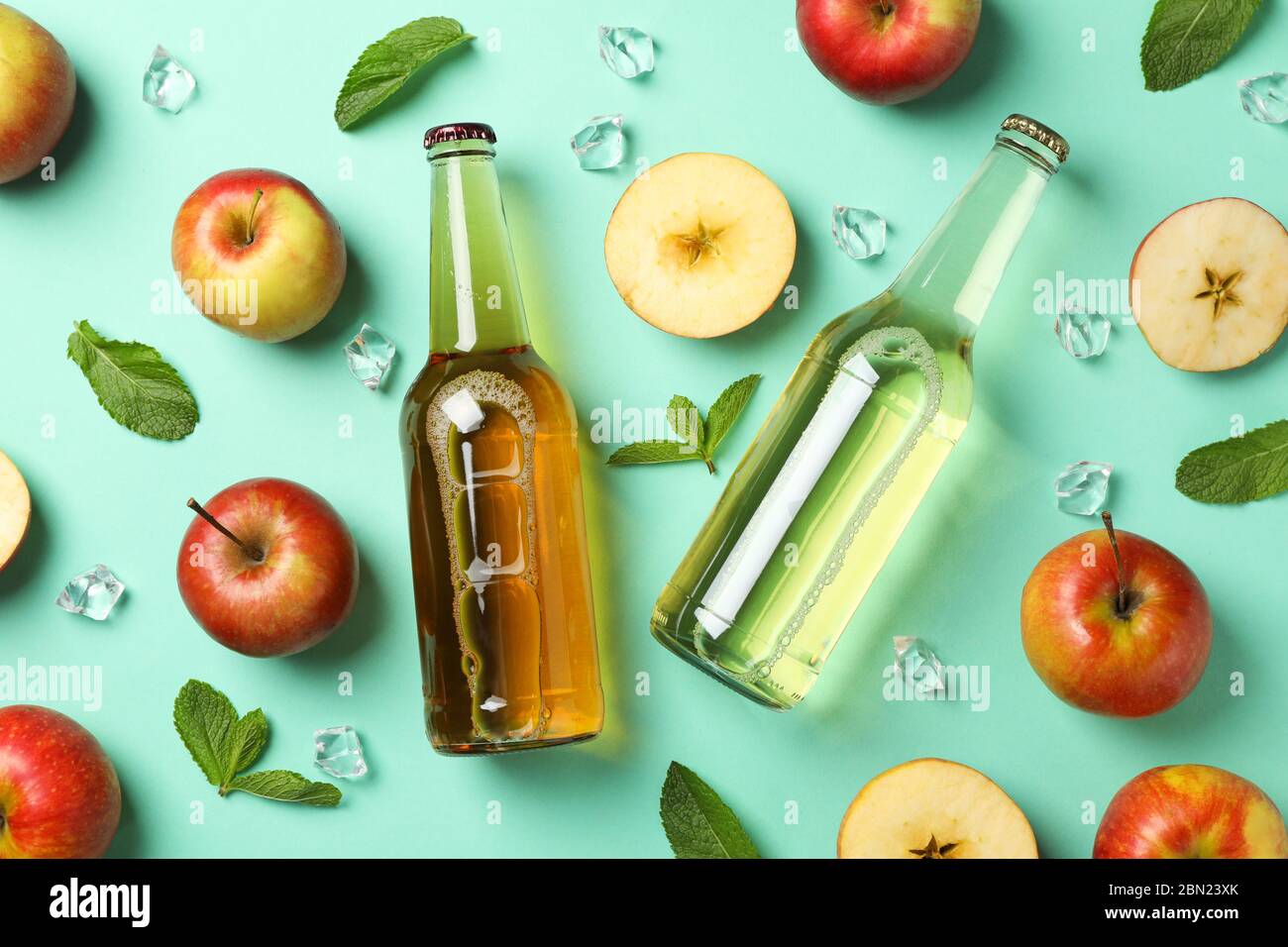 Composition with cider, apples and ice on mint background Stock Photo