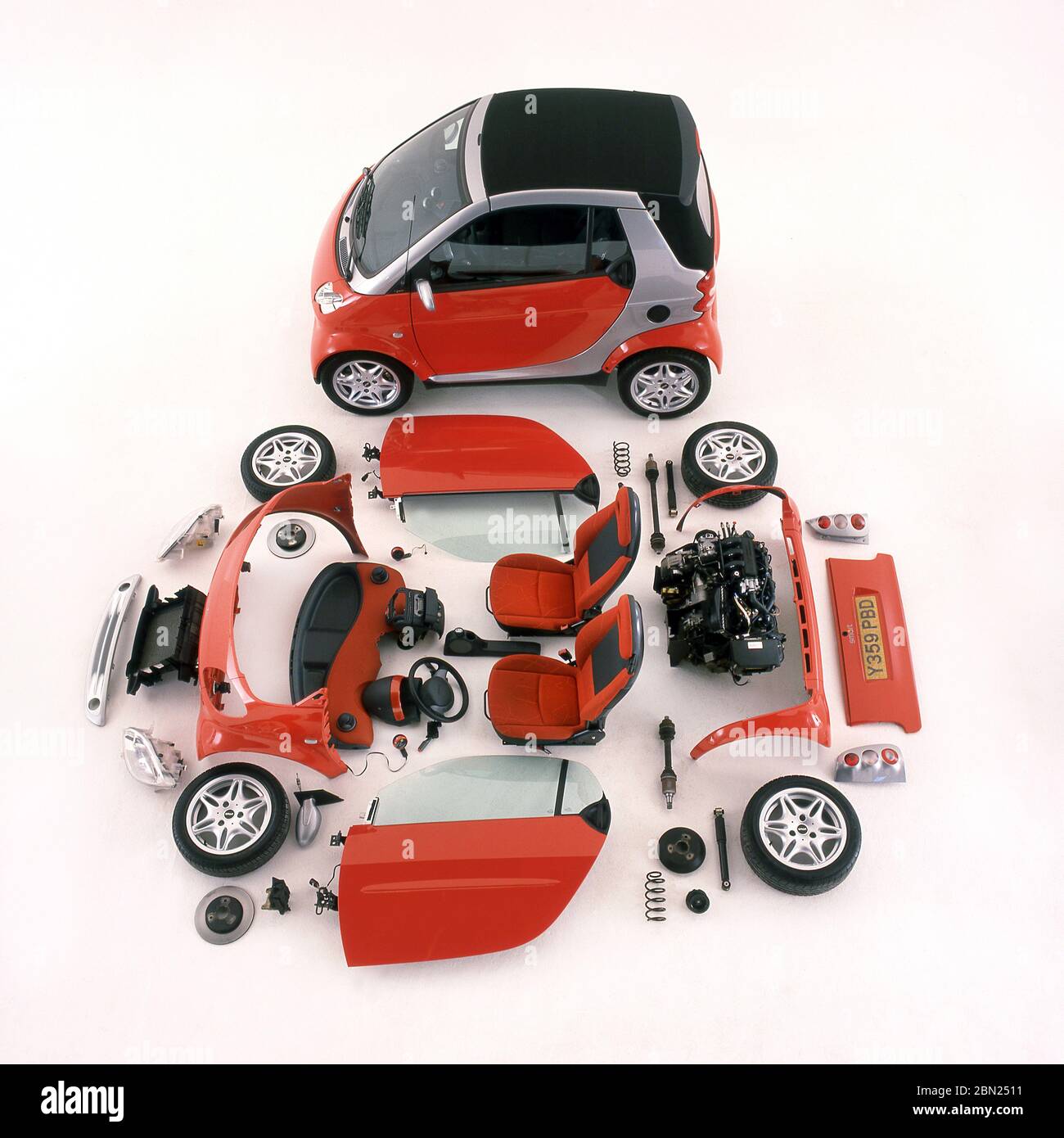 2001 Smart Two car and components that make up the car laid out on display. Stock Photo