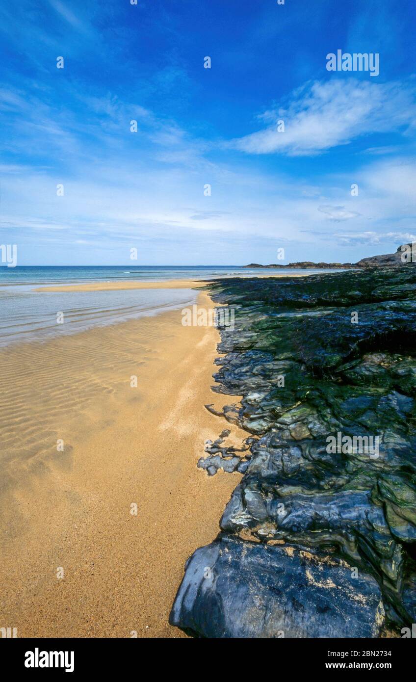 Blue sky, sandy beach and rocks abstract, Kiloran Beach on the Hebridean Isle of Colonsay in Summer, Scotland, UK Stock Photo