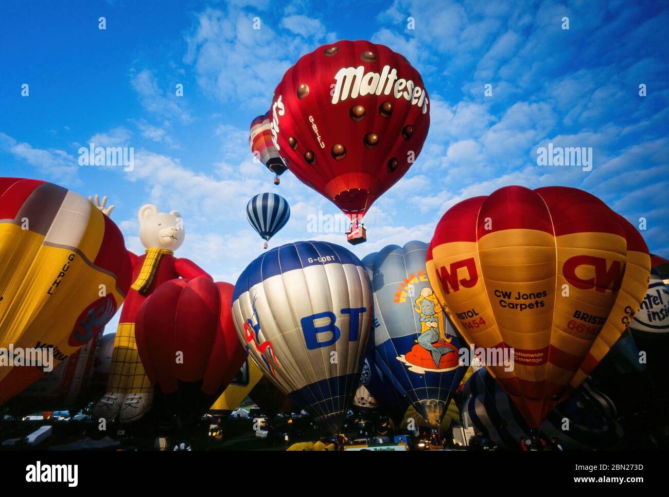 Early morning mass ascent of colourful hot air balloons at the Bristol International Balloon Fiesta, Ashton Court, Bristol, England, UK Stock Photo
