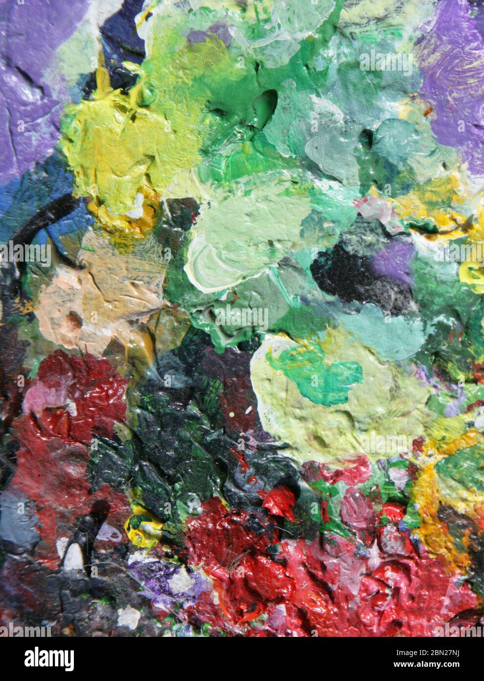 Abstract painting. Artists' palettes daubed with mixed paint. Colourful