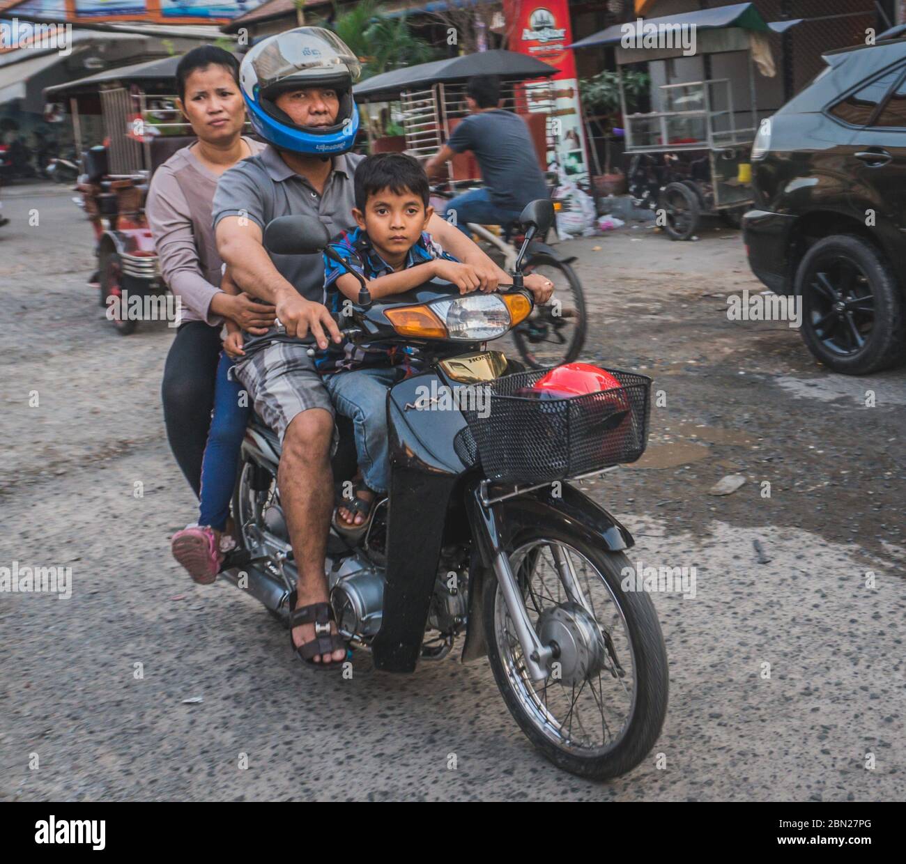 Family with children on a motorcycle, mother and her children. Transport in Asia. Phnom Penh, Cambodia - FEBRUARY 22, 2020 Stock Photo