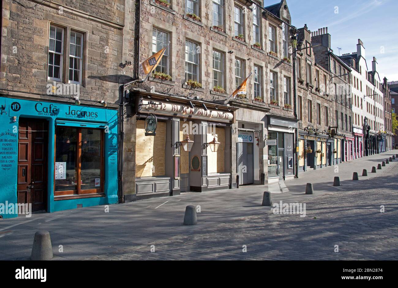 Edinburgh city centre, Scotland, UK. 12th May 2020. Fiftieth day of UK Covid-19 Coronavirus Lockdown, streets and pavements pictured show a touristless city with very little traffic or pedestrians out and about before 9.45am, pictured view up the normally busy Grassmarket. Many boarded up pubs which are not expected to open in Scotland until perhaps July. Credit: Arch White/Alamy Live News. Stock Photo
