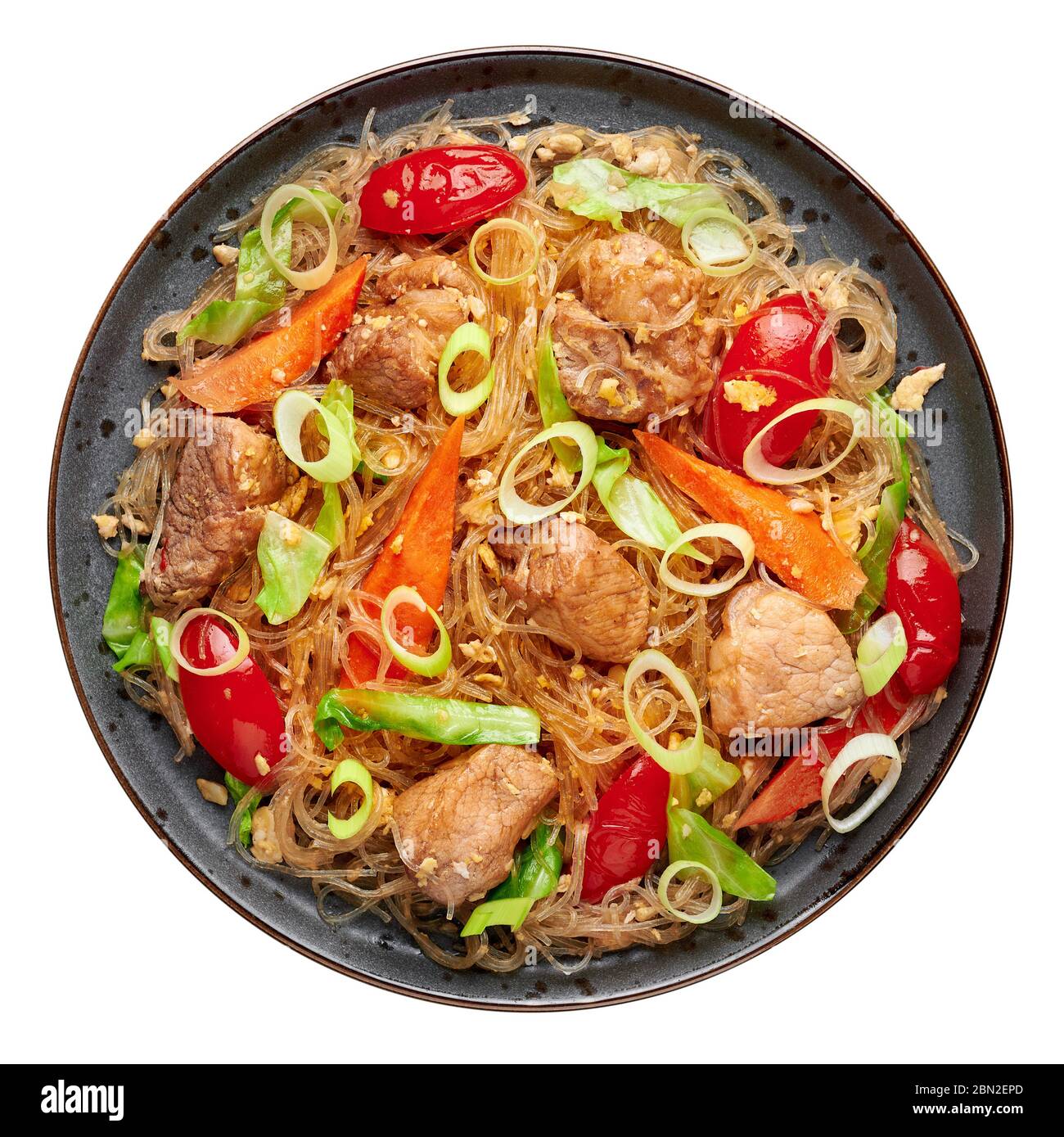 Pad Woon Sen or Thai Pork Glass Noodle Stir-Fry in black plate isolated on white backdrop. Pad Woon Sen is a Thai cuisine dish of glass bean noodles, Stock Photo