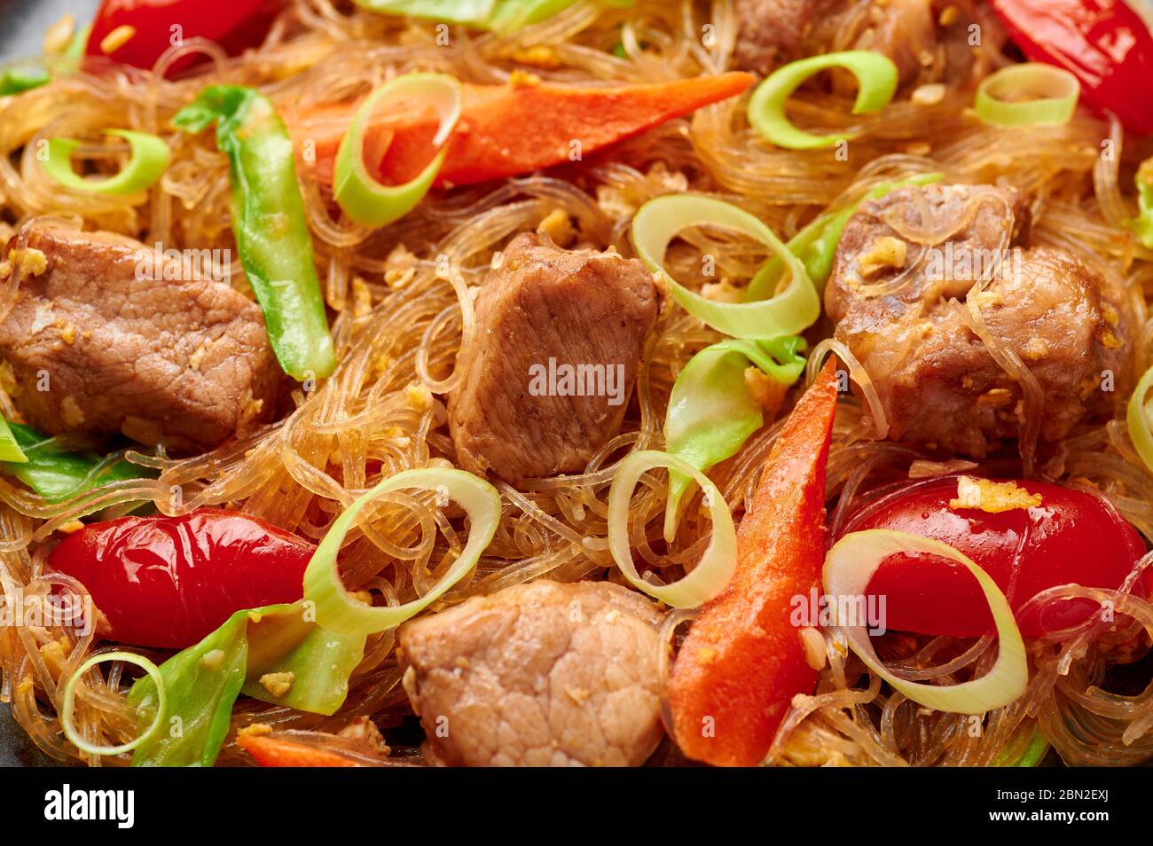 Pad Woon Sen or Thai Pork Glass Noodle Stir-Fry close up texture. Pad Woon Sen is a Thai cuisine dish of glass bean noodles, meat, tomatoes, carrots, Stock Photo