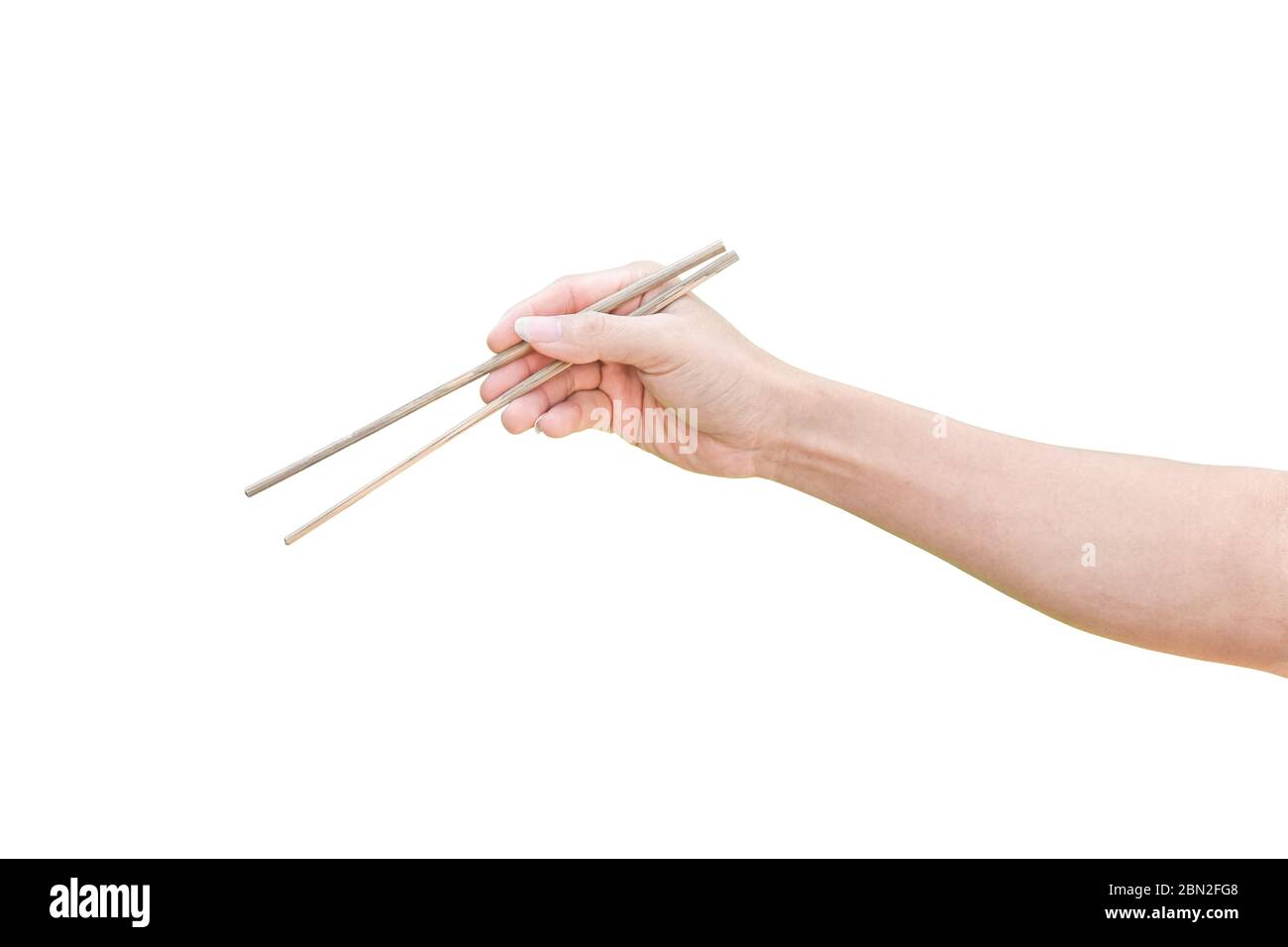 hand holding wooden chopsticks isolated on white background with clipping path. Stock Photo