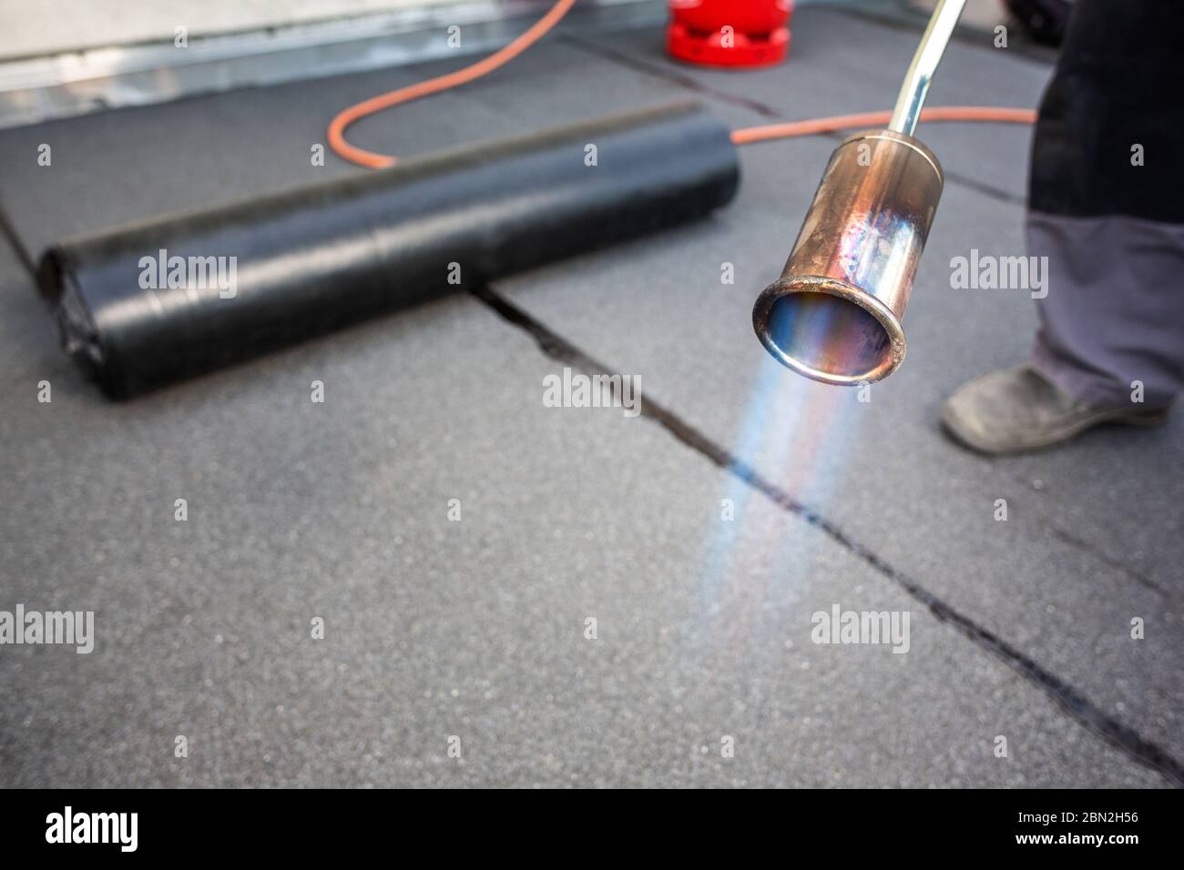 Bitumen roofing felt and burning gas torch Stock Photo
