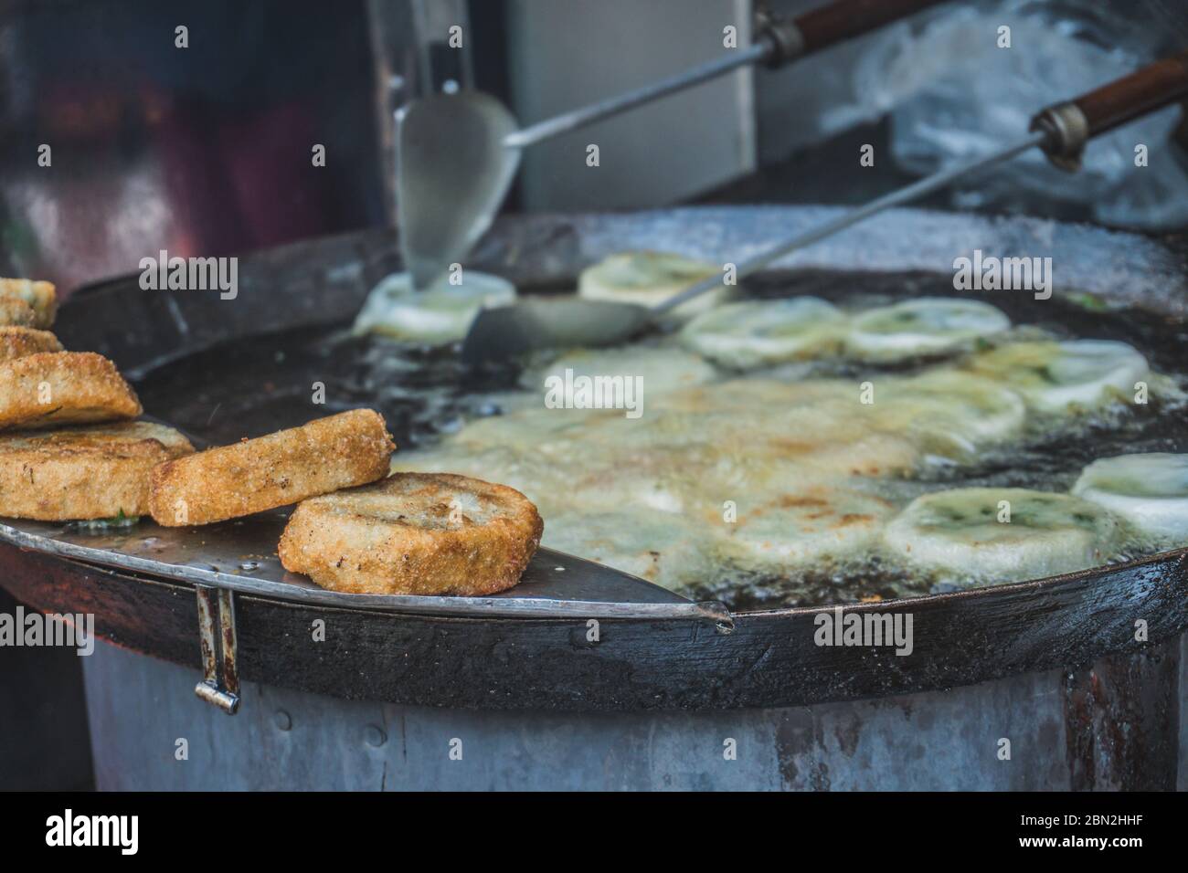 The meat in batter is fried in oil on the street. Street food market in Asia. Phnom Penh, Cambodia Stock Photo