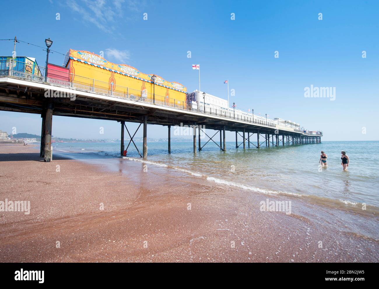 Two early morning swimmers on the near deserted beach at Paignton, UK Stock Photo