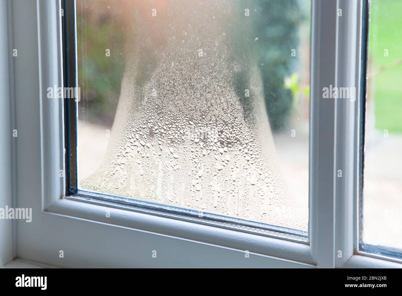 Close up of blown double glazed unit. Failed window glazing with condensation inside, UK Stock Photo