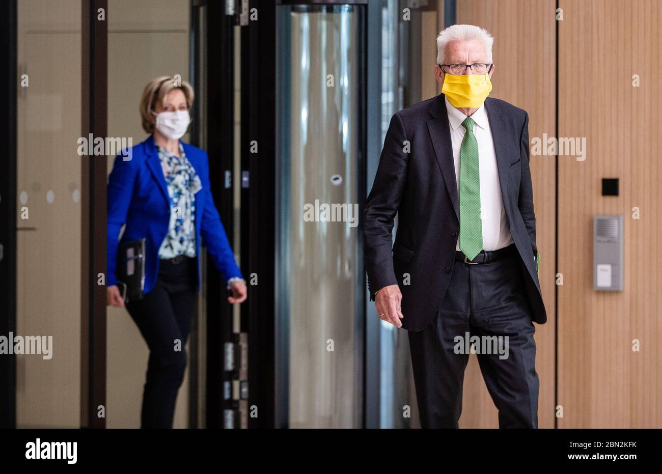 Stuttgart, Germany. 12th May, 2020. Winfried Kretschmann (r, Bündnis 90/Die Grünen), Prime Minister of Baden-Württemberg, followed by Baden-Württemberg's Minister of Economics Nicole Hoffmeister-Kraut (CDU), goes to a government press conference. At the press conference, the state government announced new aid for medium-sized businesses. Credit: Christoph Schmidt/dpa/Alamy Live News Stock Photo