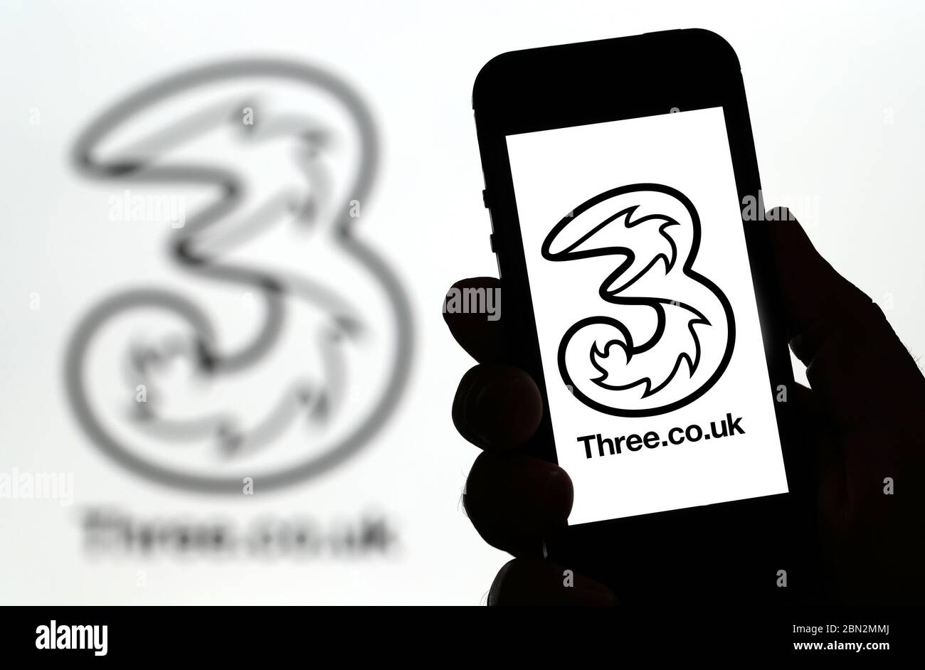 Three mobile phone network logo on a mobile phone (Editorial use only) Stock Photo