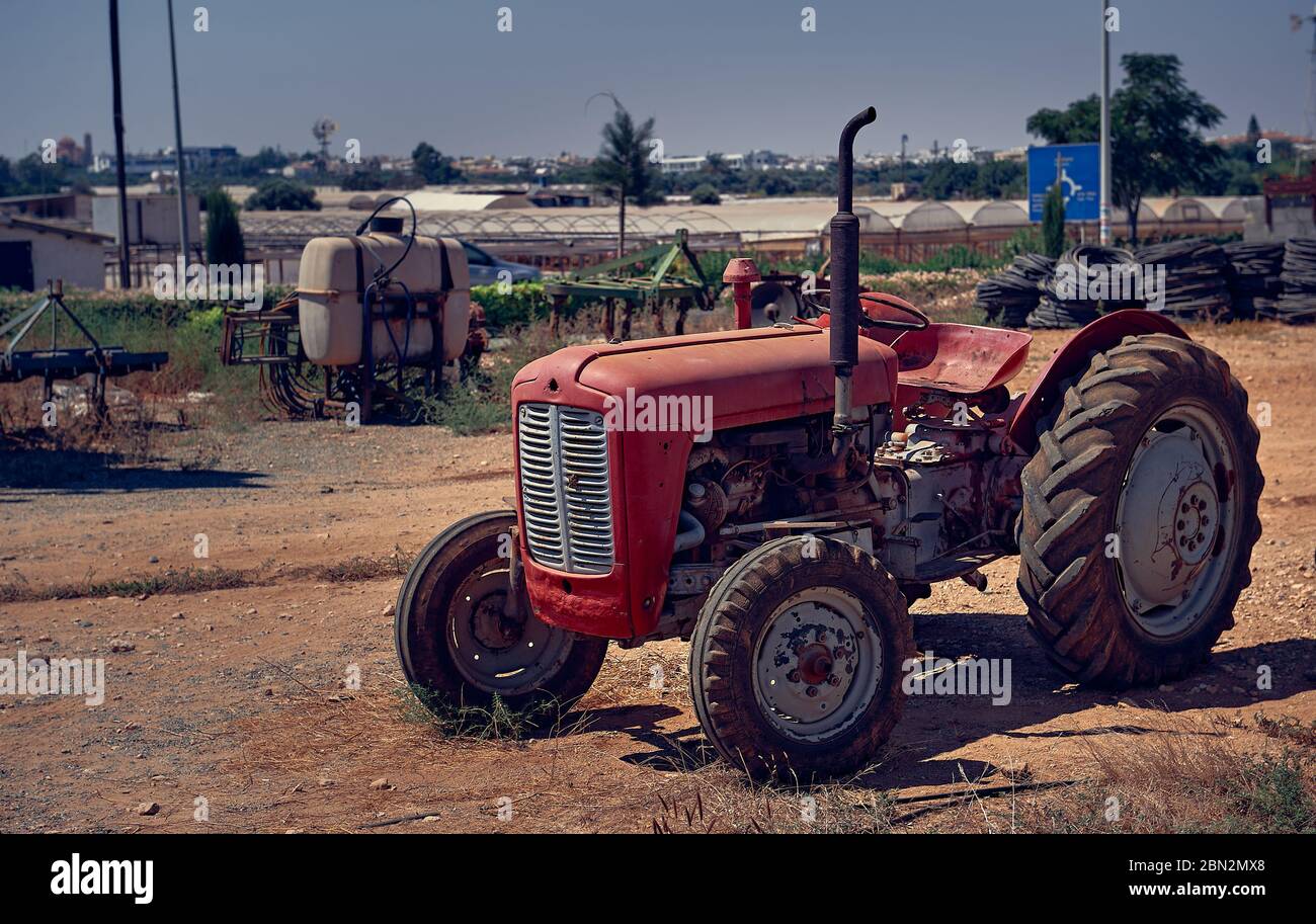 Protaras, Cyprus, 2015: Old wheeled farmyard tractor, stylized Stock Photo