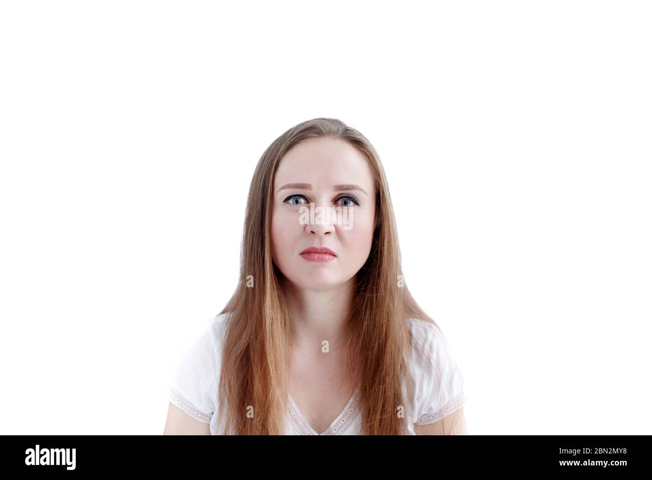 Confused young caucasian woman with disgusted facial expression and grimacing, isolated on white background. Negative emotion. Stock Photo