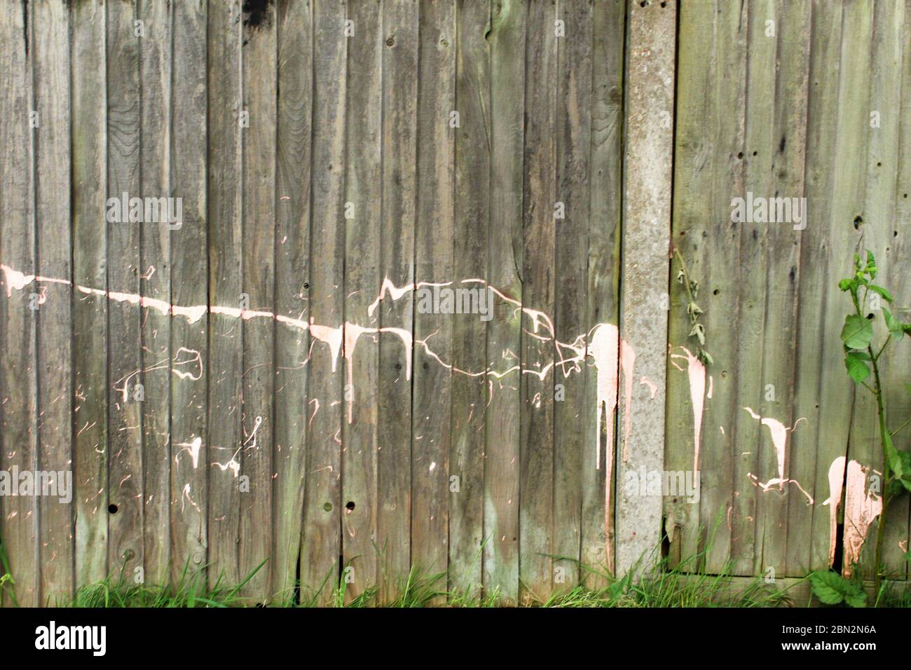 Splattered pink paint on an old fence in Manchester, England Stock Photo