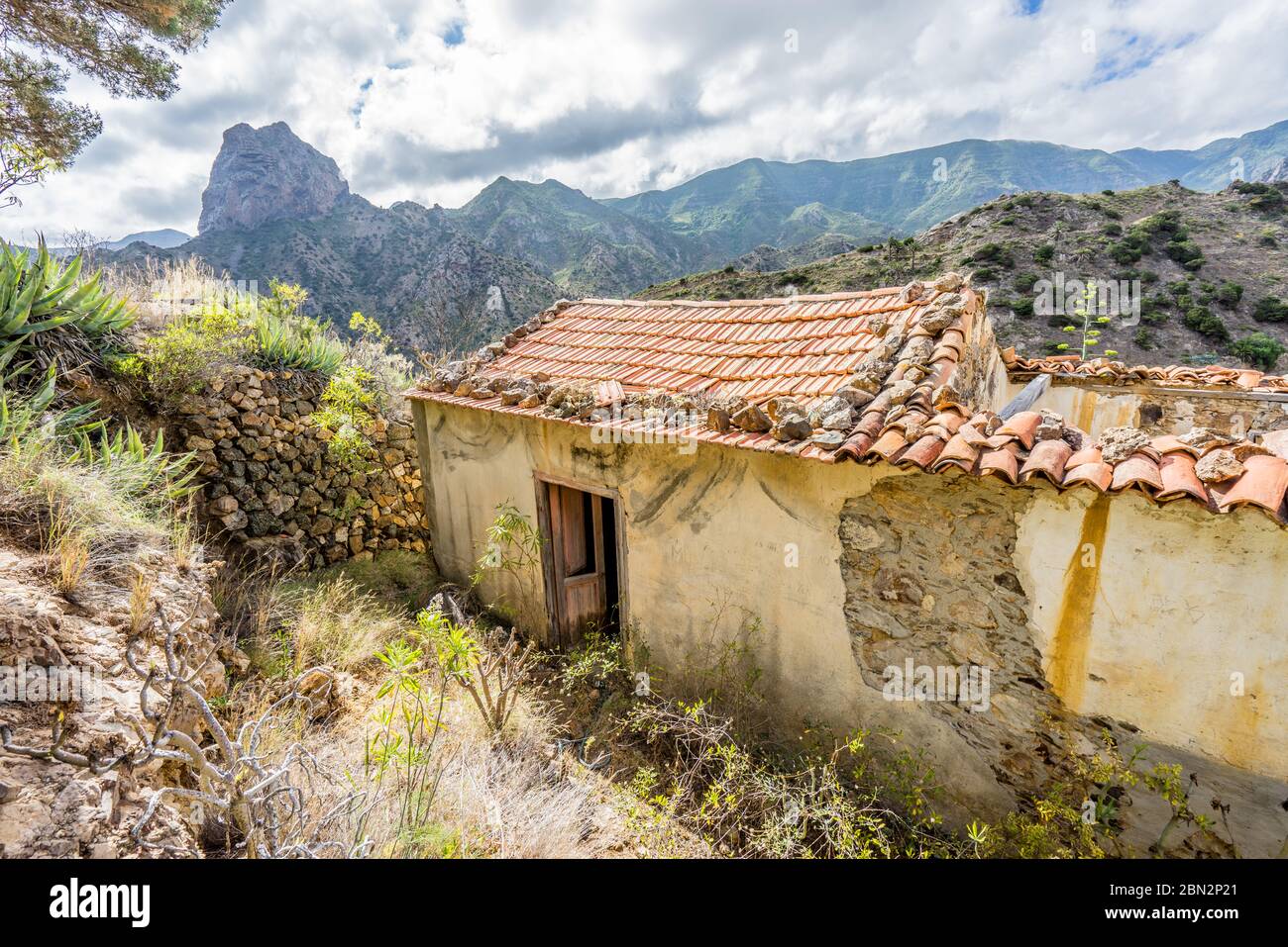hidden abandoned house at La Gomera discovered while hiking in beautiful mountain range. Weathered, decayed and isolated damaged and spooky building o Stock Photo