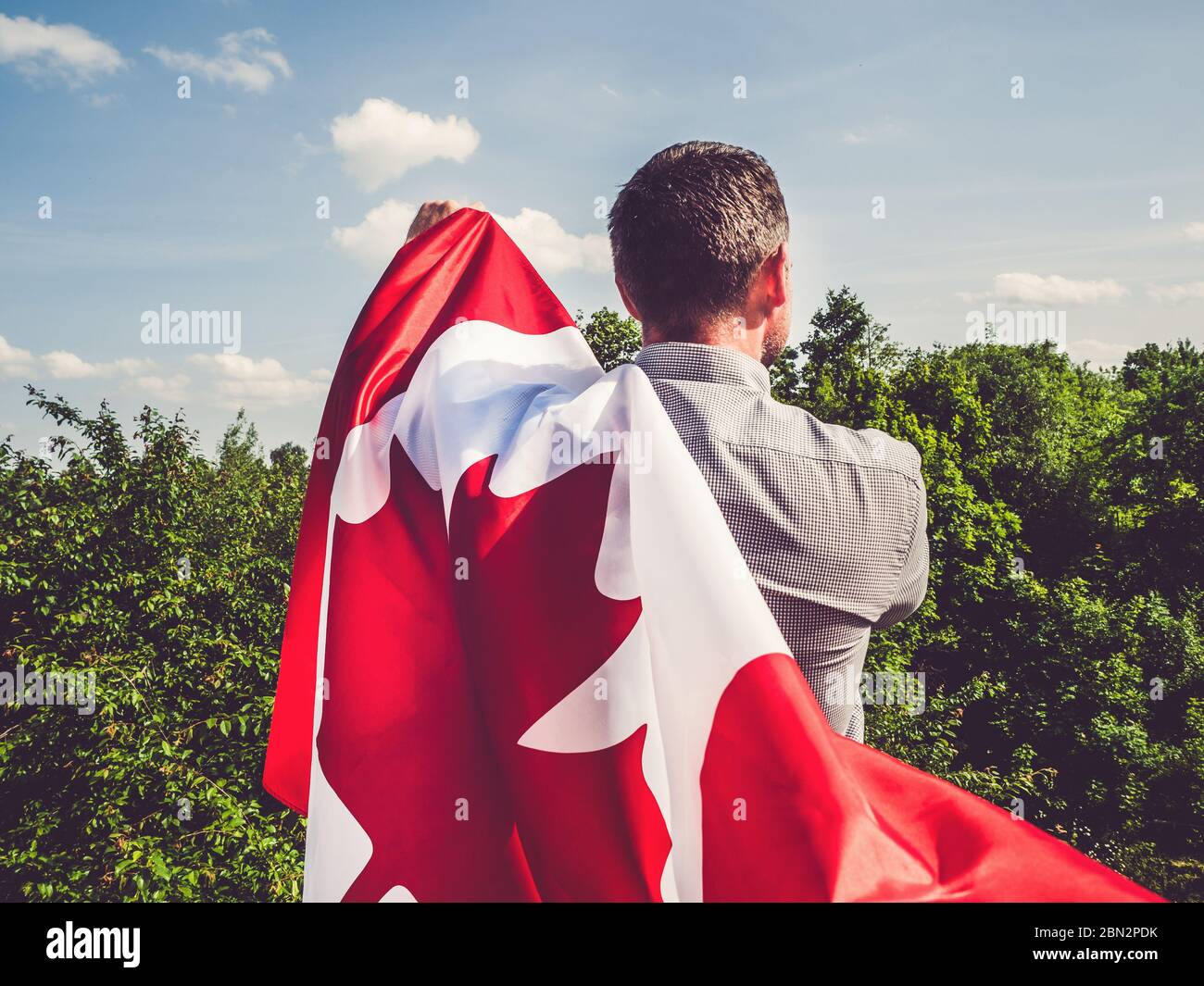 Attractive man holding Canadian Flag. National holiday Stock Photo - Alamy