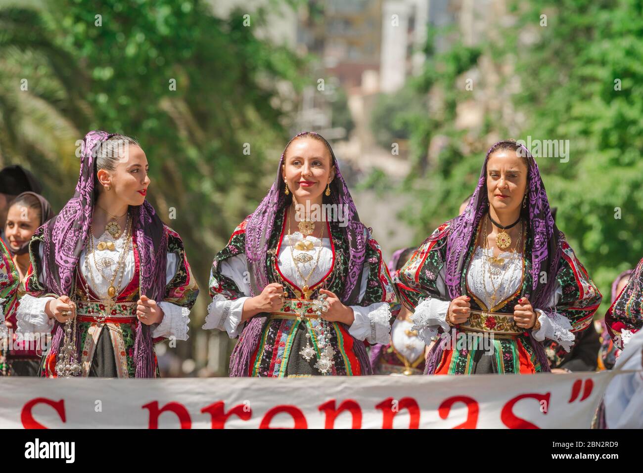 Traditional costume, portrait of three young women in traditional costume during the grand parade of the Cavalcata festival in Sassari, Sardinia Stock Photo