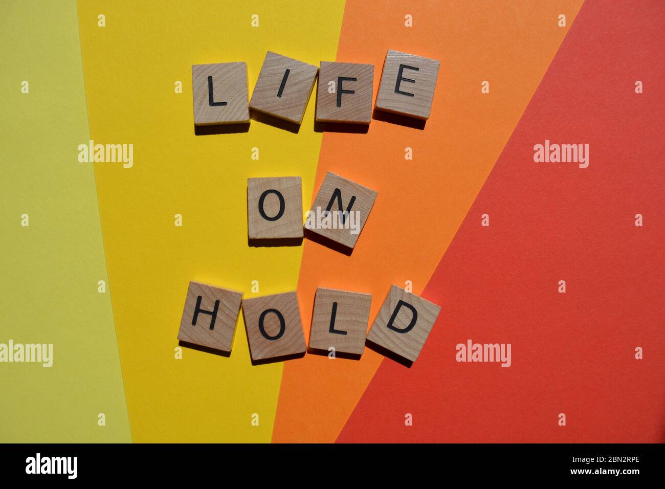 Life on Hold, words in 3d wooden alphabet letters isolated on colourful background Stock Photo