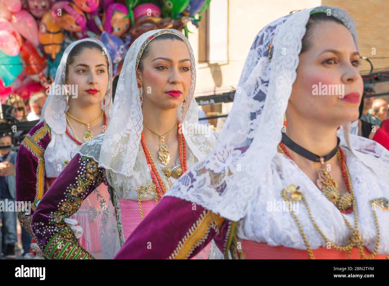 Sardinia festival Cavalcata, view of Sardinian women in traditional costume participating in the Cavalcata grand procession through Sassari, Sardinia. Stock Photo
